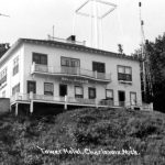 This hotel began as the Oldham Club, an exclusive dining club with eleven guest rooms built in the 1920s by Harry Oldham on the Park Avenue bluff a few yards from the water tower. The Coast Guard signal flag tower is to the building’s right. The Club discreetly catered to high rollers with a little unpublicized gambling on the side. Its balcony and porch provided a spectacular northwest view of Lake Michigan. In the 1930s, new owners changed the name to the Tower Hotel. Most of it came down in the 1970s, after which the rest was incorporated into the Sandcastle Condominiums in the early 1970s. Oldham Club