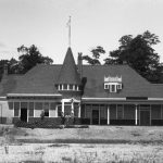 The depot overlooks Lake Charlevoix at the far end of East Dixon Avenue. The first train puffed into Charlevoix in 1892, nineteen years after Petoskey, only 15.5 miles away, received its railroad. The reason that Charlevoix lagged for so long was that the port was so close to the Lake Michigan maritime lanes a railroad was long thought to be unnecessary. But finally the train arrived at an almost finished station, shown here, on June 26. It was one of the major events of Charlevoix’s history. The Charlevoix Historical Society owns the depot. Charlevoix Depot 1892