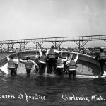 Life-saving drills were regularly held in the channel along with breeches buoy drills carried out along a cable suspended high over the channel to a tall pole on the north bank. The “surf boat” was considered to be unsinkable. In the early days these drills were one of the biggest attractions in town. On the 4th of July hundreds of onlookers lined both piers and embankments, in places shoulder to shoulder, many accompanied by blankets and picnic baskets. Life-saving drills