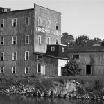 A host of businesses have come and gone in Charlevoix. In 1885 Hiram Rifenburg constructed a gristmill on the north side of the channel next to the bridge. In 1896 new owners incorporated the business as the Charlevoix Roller Mills. On December 1, 1903, the operation was incorporated as the Argo Milling Company and flourished for about three decades. In August of 1953, after ten years of negotiations, Earl Young bought the empty rusted building, tore most of it down, and replaced the beloved eyesore with the Weathervane Inn. Argo Milling Company