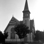 In 1883, the First Congregational Church purchased a lot for $800 on the southwest corner of Main Street (Park Avenue) and State Street across from and to the north of the Methodists. Most of the building materials and labor were donated. A constant round of social functions kept the coffers partially filled. In the spring of 1884 a three-quarter-ton bell was installed. Finally, on a stormy January 18, 1885, parishioners braved the blowing snow to fill the sanctuary and dedicate the debt-free church. Total construction cost: $5,541.71. It is one of the most beautiful structures in Charlevoix. First Congregational Church