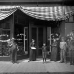 J. H. Mullen’s Gents Furnishings occupied the south half of the street floor of the opera house. The stairs to Dr. Lewis’ office, the box office and the auditorium are at right J. H. Mullen’s Gents Furnishings