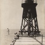For a short time, the original wooden South Pier Light included a diving board from the pier into Lake Michigan. Photograph is property of the Charlevoix Historical Society.