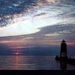 A great view of the South Pier Light and Lake Michigan from Lake Michigan Beach. Photograph is property of the Charlevoix Historical Society.