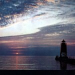 A great view of the South Pier Light and Lake Michigan from Lake Michigan Beach. Photograph is property of the Charlevoix Historical Society.