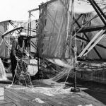 The open spaces and docks on the south shore of Round Lake were once blanketed by fish net reels wrapped in layers of gossamer netting. Miles of it were made by the hundreds of pounds every winter. In the winter of 1902, fisherman John O’Neill employed fifteen people to repair old and weave additional nets. They produced 544 new ones weighing 1600 pounds that would stretch 85 miles in the water. That spring, using fifteen men in three tugs, he set out a combined 125 miles of new and old netting throughout northern Lake Michigan. Round lake Fish net reels