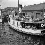 The Hum was a popular little passenger steamer that ran three to four times a day between Charlevoix and East Jordan. George Jepson of East Jordan converted the yacht Pilgrim to the Hum in 1905, naming her for Florence “Hum” Smith, daughter of Charlevoix Sentinel publisher/editor Willard Smith. The two families were longtime friends. Little Florence had acquired the nickname as she played with her dolls, humming to them, and the sound made by his boat reminded Jepson of the child. The Hum