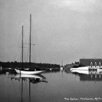 In the middle background, the Sylvia rests at her berth near the Belvedere Club. To her right is the Reomar IV. This had been the Sylvia IV until Logan Thompson sold the 135-foot yacht to auto magnate Ransom E. Olds once he bought the larger unnumbered Sylvia. Olds named his boats after the initials of his name and the first three letters of his wife’s name. Like most of her kind, she was confiscated by the government for war duty in 1942. Thompson had built the long boathouse for the Sylvia IV. The building is now the Harbour Club Condominiums. The Harbor