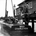 Roy Brady, renowned racing boat builder shown here with his wife, built this boat in Charlevoix. On August 7, 1927 he entered Miss Charlevoix in a five-mile event on Lake Charlevoix. The first 2.5 miles were covered in just under 2 minutes, 20 seconds for an average 64.5 miles per hour, a world record. On September 2, Brady went from a standing start to the mile mark in 68 seconds, a state record. The Charlevoix Courier said, “ . . . very few boats in the entire world . . . can show her a clean pair of heels.” Roy Brady and his racing boat Miss Charlevoix