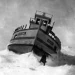 The freighter Welcome was stranded on the South Point rocks southwest of the piers around 1904-05. A few years of battering began to take her apart. One particularly severe winter saw her lifted and listing to port as if on a frozen wave. Stranded freighter