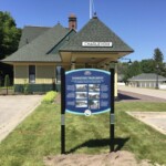 The Train Depot and the Inn Hotel Charlevoix Historical Signs