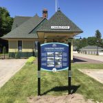 The Train Depot and the Inn Hotel Charlevoix Historical Signs
